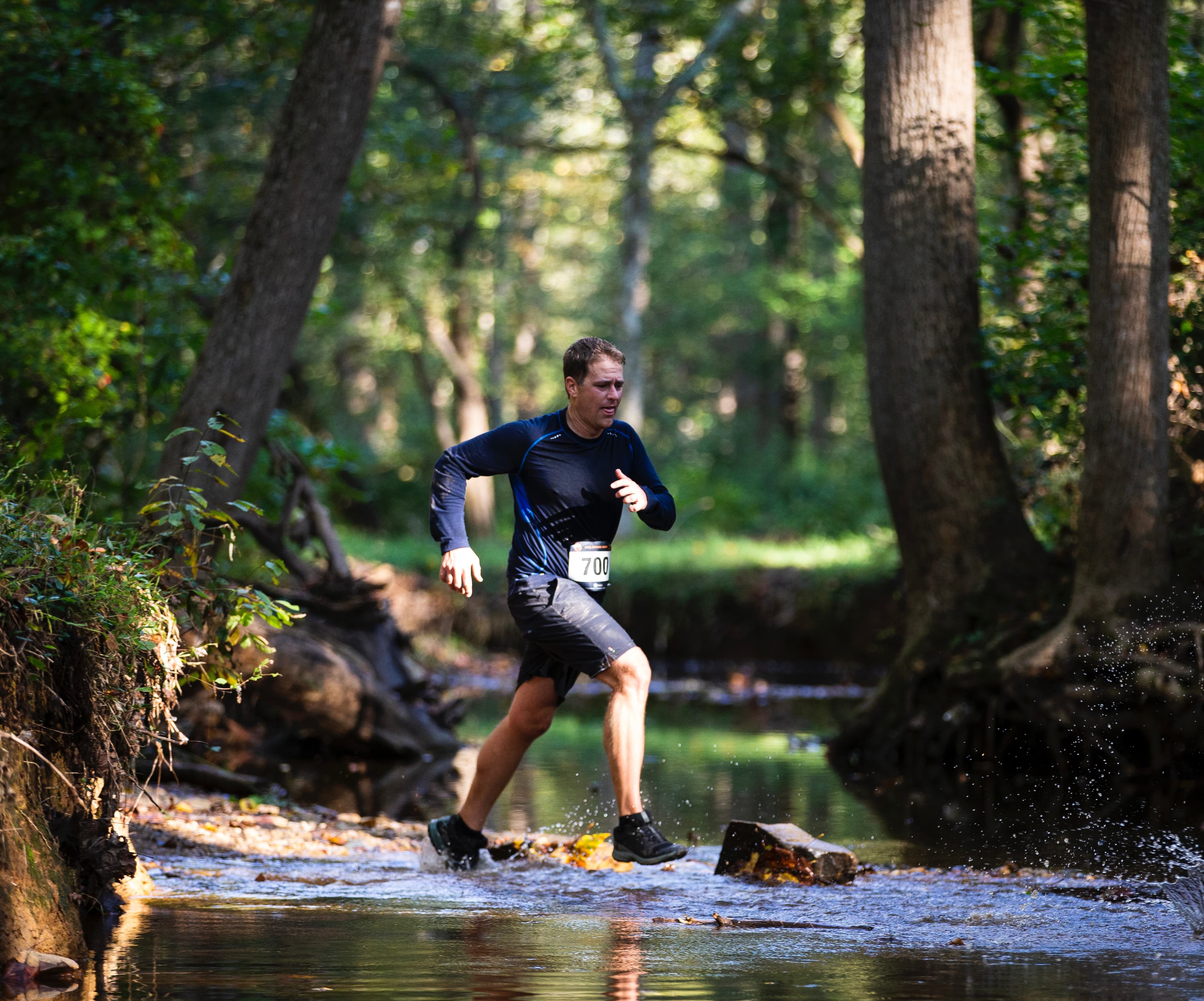 Tim Cook in middle of river in a running race.
